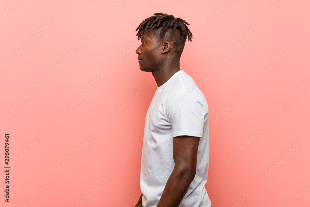 Young african black man gazing left, sideways pose. Young african black man gazing left, sideways pose.