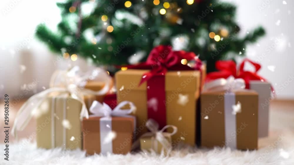 holidays, new year and celebration concept - pile of gift boxes on sheepskin near christmas tree holidays, new year and celebration concept - pile of gift boxes on sheepskin near christmas tree