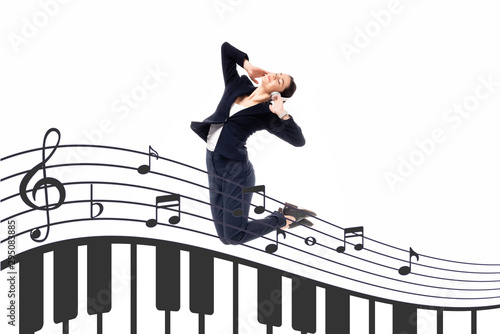 young businesswoman jumping in dance near illustration with music notes and piano keys isolated on white