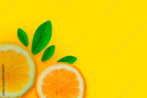 Lemon vitamin C. Fresh orange citrus fruit with leaves isolated yellow backgrounds. Flat lay copy space