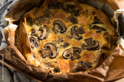 Quishe with mushrooms on a wooden plate photo