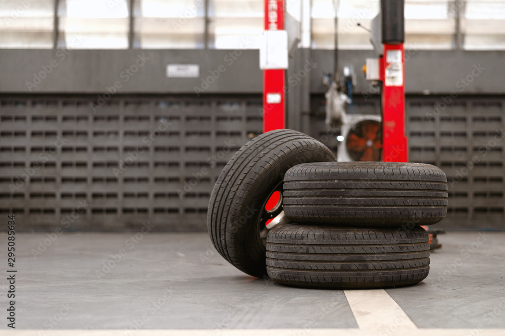 closeup old tire in car repair station with soft-focus and over light in the background closeup old tire in car repair station with soft-focus and over light in the background