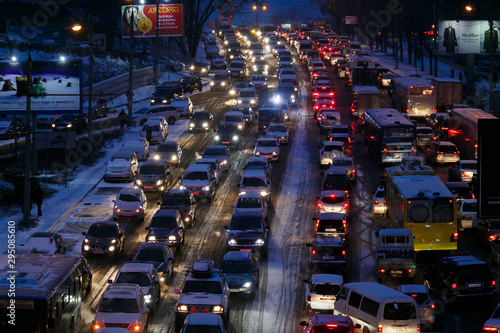 Car traffic jams due to snowfall in the evening.