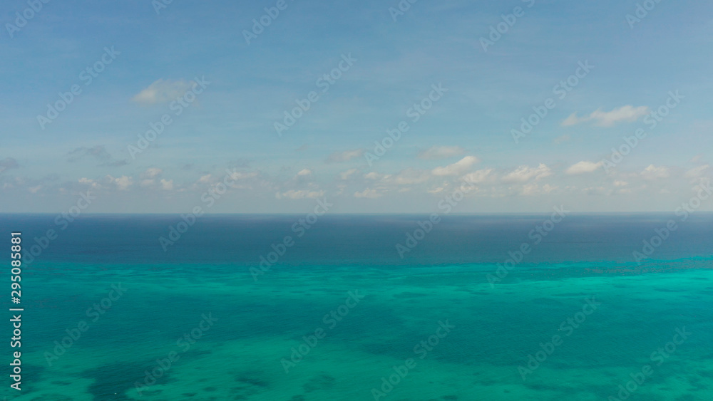 Flying over the sea with turquoise water, atoll and coral reef, aerial view. Balabac, Palawan, Philippines. Summer and travel vacation concept.