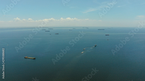 Fototapeta Naklejka Na Ścianę i Meble -  Arial view of ships at anchor in Manila Bay. Cargo ships in the harbor.