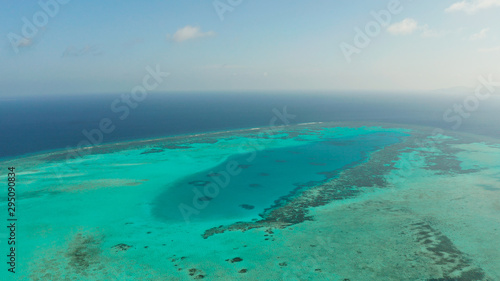 Tropical islands and coral atolls with blue water of the sea, aerial view. Balabac, Palawan, Philippines. Summer and travel vacation concept.