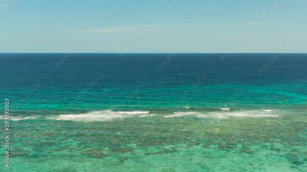 Blue background with transparent sea water copy space for text. Sea water surface in lagoon and coral reef. Top view transparent turquoise ocean water surface. background texture