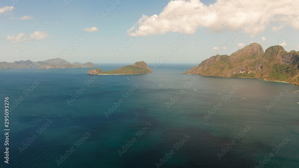Bay and the tropical islands. Seascape with tropical rocky islands, ocean blue wate, aerial view. islands and mountains covered with tropical forest. El nido, Philippines, Palawan. Tropical Mountain
