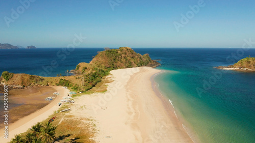 Blue sea and tropical beach  aerial drone. Nacpan  El Nido  Palawan  Philippine Islands. Seascape with tropical beach and islands. Summer and travel vacation concept