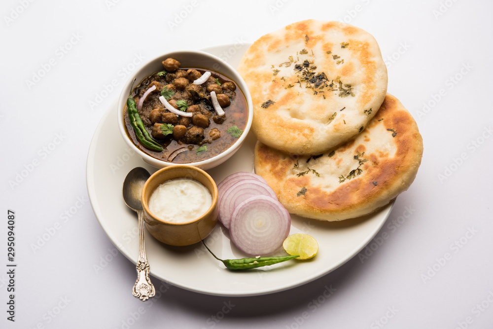 Pindi Chole Kulche or roadside choley Kulcha popular in India and pakistan is a popular streetfood. It's a spicy Chickpea or chana curry served with Indian Flat Bread. selective focus Pindi Chole Kulche or roadside choley Kulcha popular in India and pakistan is a popular streetfood. It's a spicy Chickpea or chana curry served with Indian Flat Bread. selective focus