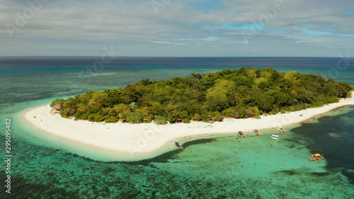 Tropical island Mantigue and sandy beach surrounded by atoll coral reef and blue sea  aerial view. Small island with sandy beach. Summer and travel vacation concept  Camiguin Philippines Mindanao