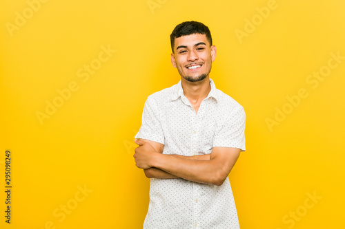 Young hispanic man laughing and having fun.