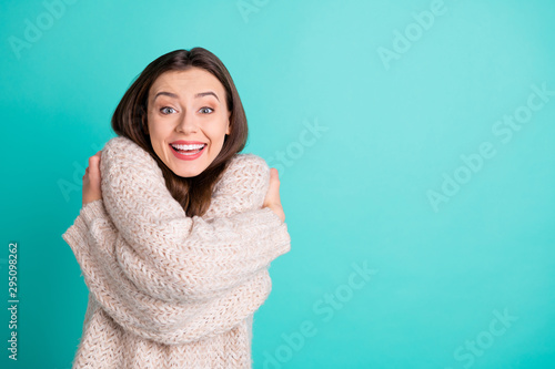 Fotografie Portrait of crazy funky girl hug herself impressed by quality warm soft pullover