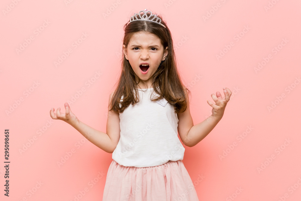 Little girl wearing a princess look screaming with rage. Little girl wearing a princess look screaming with rage.