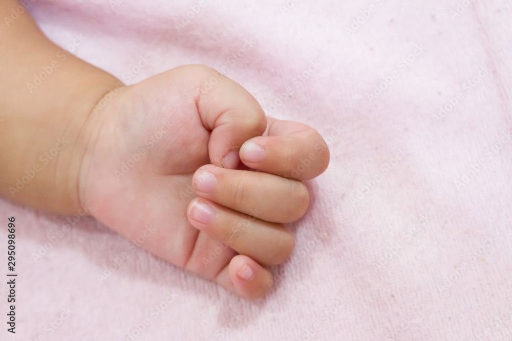 Right hand side of a baby on pink background. Newborn baby hand Right hand side of a baby on pink background. Newborn baby hand