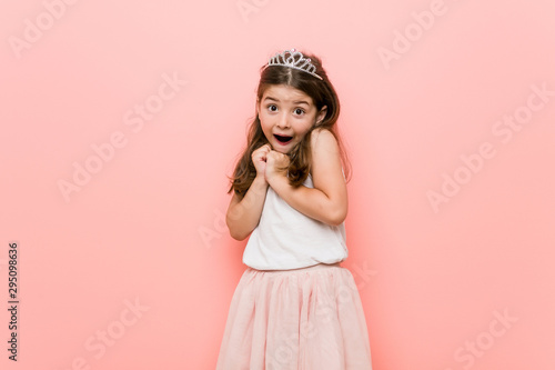 Little girl wearing a princess look scared and afraid.