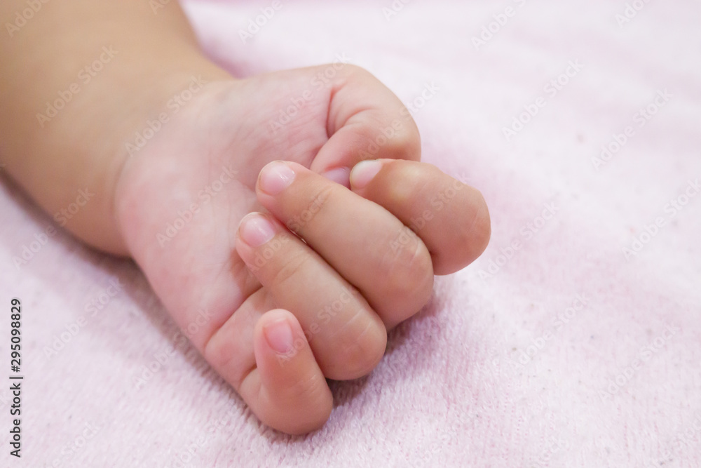 Right hand side of a baby on pink background. Newborn baby hand Right hand side of a baby on pink background. Newborn baby hand