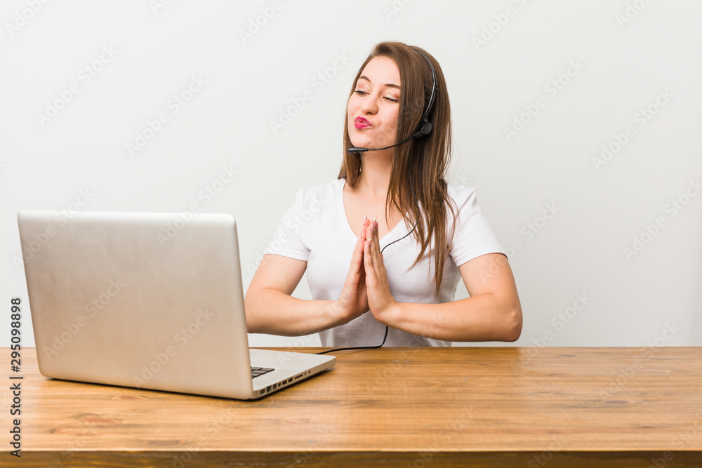 Young telemarketer woman making up plan in mind, setting up an idea. Young telemarketer woman making up plan in mind, setting up an idea.
