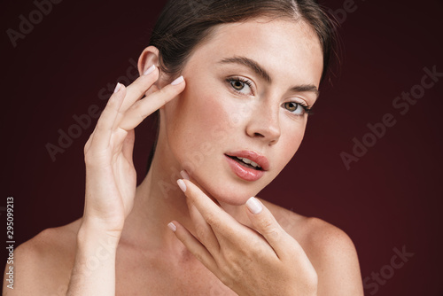 Image of attractive shirtless woman touching her clean fresh face