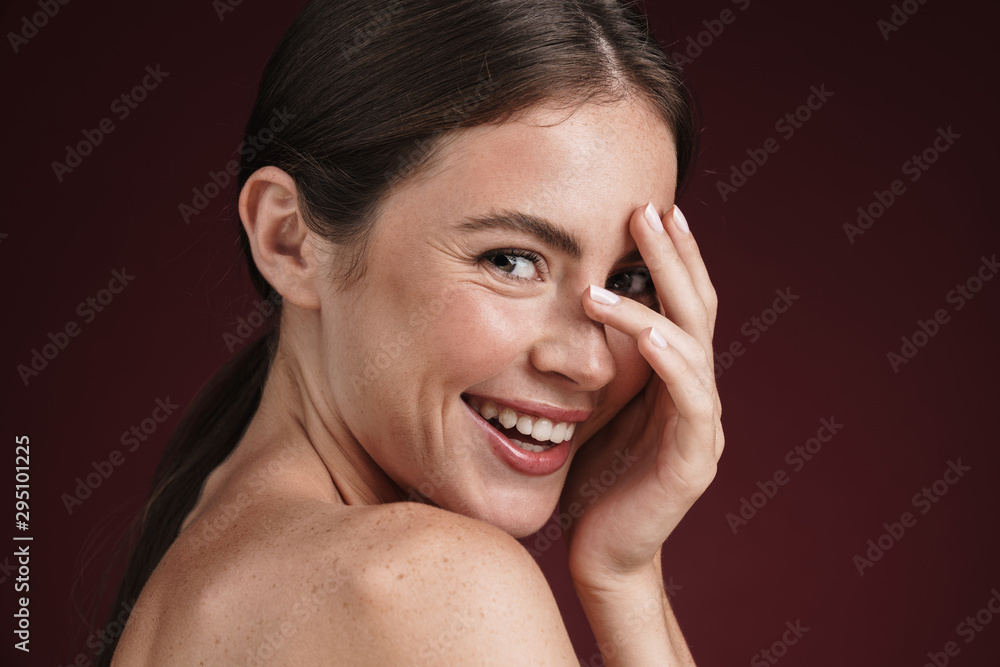 Image of brunette shirtless woman with clean fresh face smiling at camera Image of brunette shirtless woman with clean fresh face smiling at camera