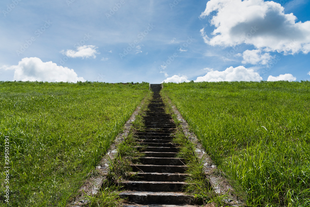 A stone staircase rises in the blue sky. The concept of stairway to heaven,The concept of growth up, road to sky