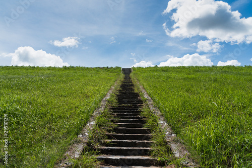 A stone staircase rises in the blue sky. The concept of stairway to heaven,The concept of growth up, road to sky