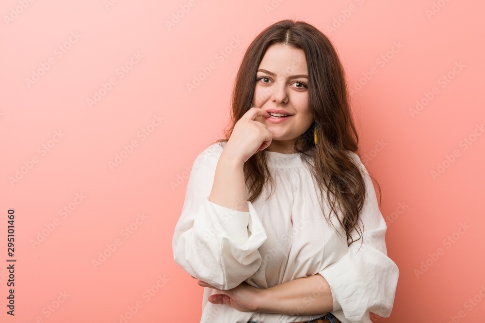 Young caucasian curvy woman standing against pink background Young caucasian curvy woman standing against pink background