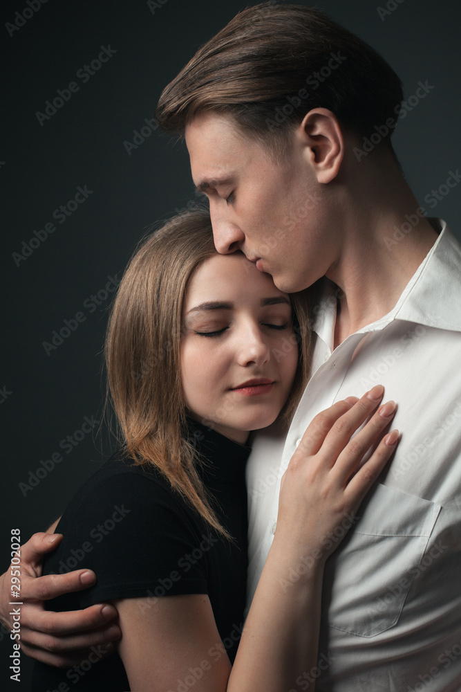 Young passionate couple in love hugging in studio. Young passionate couple in love hugging in studio.