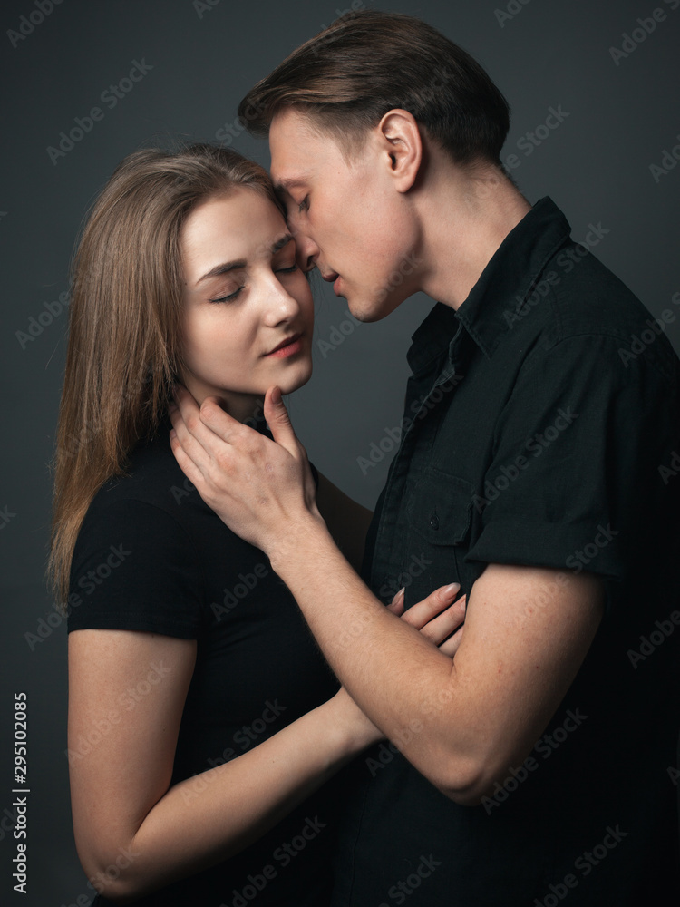 Young couple in love kissing in studio. Low key. Young couple in love kissing in studio. Low key.