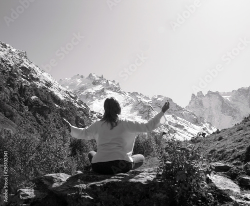 Woman meditating yoga in mountain gorge. Travel. Lifestyle. Relaxation. Emotional concept. Outdoor adventure. Harmony with nature.