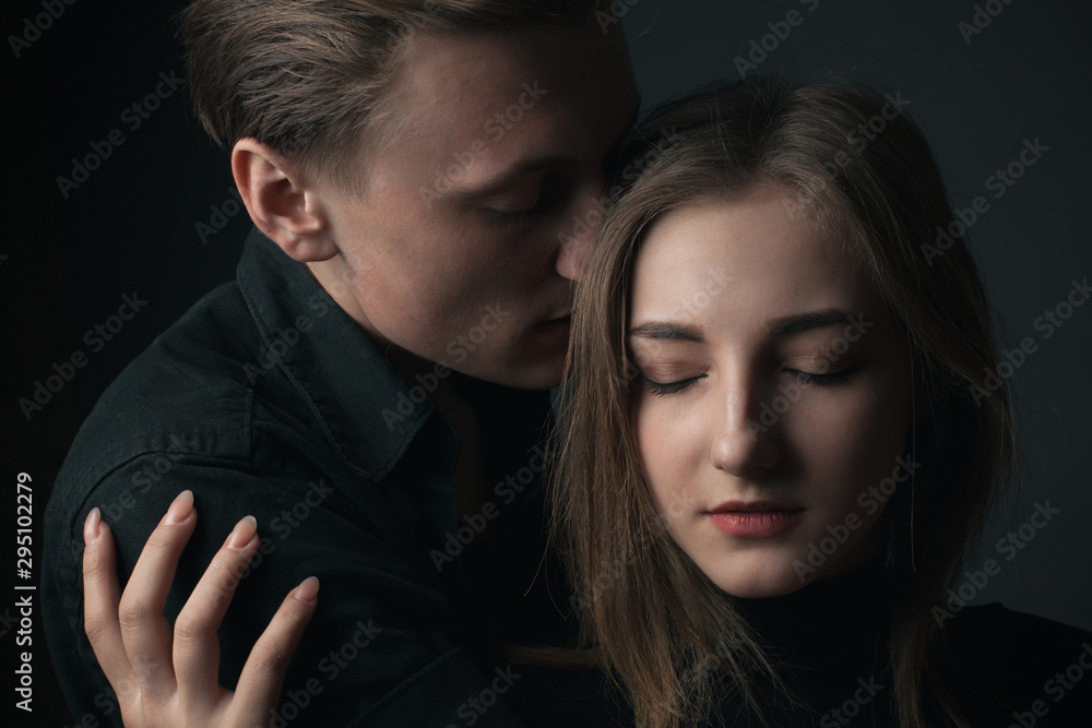 Portrait of passionate young couple in love. Close up.