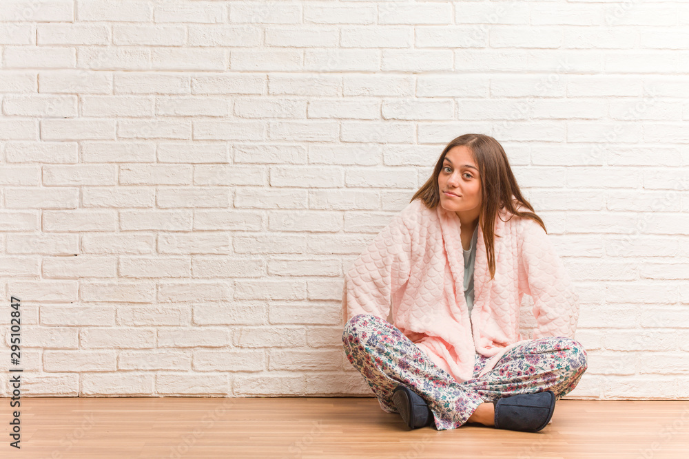 Young woman wearing pajama scolding someone very angry Young woman wearing pajama scolding someone very angry