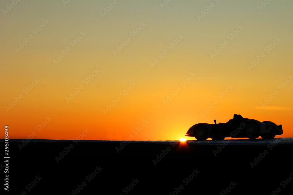 Fototapeta premium Car on a sunset background. Beautiful landscape. Car in the shade