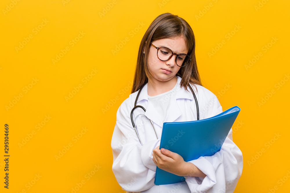 Little caucasian girl wearing a doctor costume Little caucasian girl wearing a doctor costume