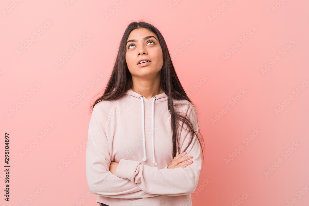 Fototapeta premium Young pretty arab woman wearing a casual sport look tired of a repetitive task.
