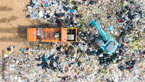 Garbage trucks unload garbage to open landfill, Surface and subsurface water contamination, modern hydraulic. Aerial top view garbage pile