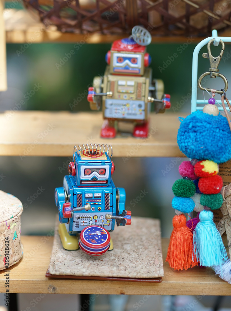 Robot toy. A soft focus of a blue vintage robot toy playing drum on the wooden shelf. Robot toy. A soft focus of a blue vintage robot toy playing drum on the wooden shelf.
