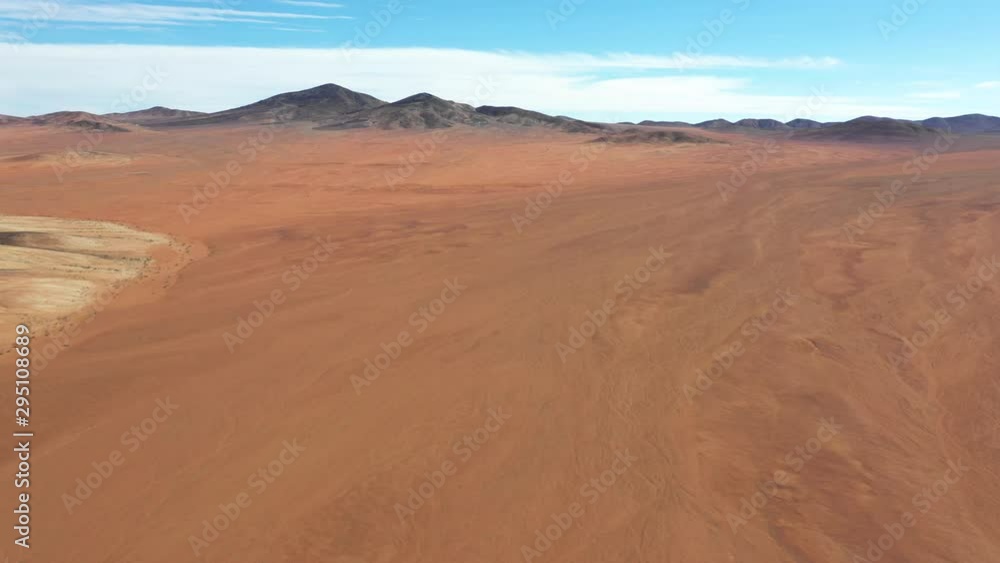 Exploring Atacama Desert vast dry extensions in the driest area of this amazing desert with an all terrain vehicle. An awe road trip adventure crossing the infinite sand extensions from an aerial view Exploring Atacama Desert vast dry extensions in the driest area of this amazing desert with an all terrain vehicle. An awe road trip adventure crossing the infinite sand extensions from an aerial view