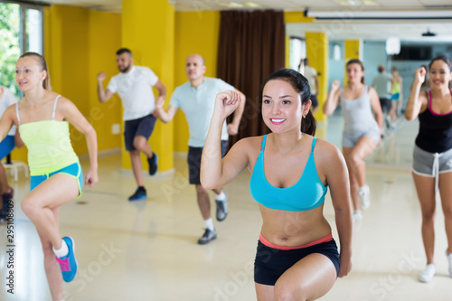 Group of young women and men exercising