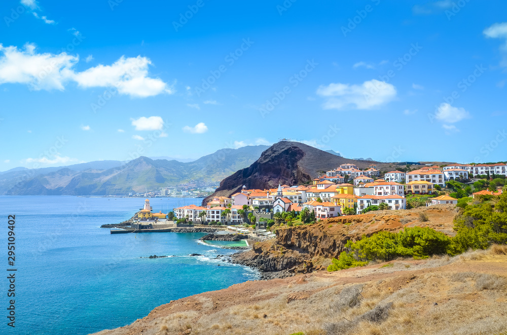 Beautiful Marina da Quinta Grande in Madeira island, Portugal. Small village, harbour located by Ponta de Sao Lourenco. Rocks and hills behind the city by the Atlantic ocean. Cityscape. Travel places