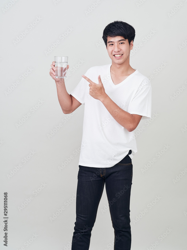 Young smiling man holding water glass Young smiling man holding water glass