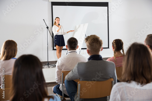 Female student answering in front of student group