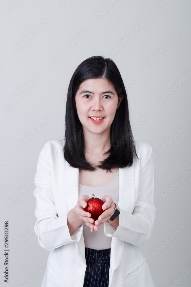 Asian woman hand holding a christmas red ball Asian woman hand holding a christmas red ball