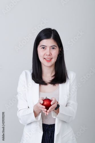 Asian woman hand holding a christmas red ball