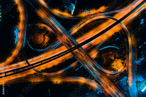 Rail track and conductor rail transportation, Aerial top view, Road Expressway traffic highway roundabout transportation with moving cars and railway tracks on which the train rides
