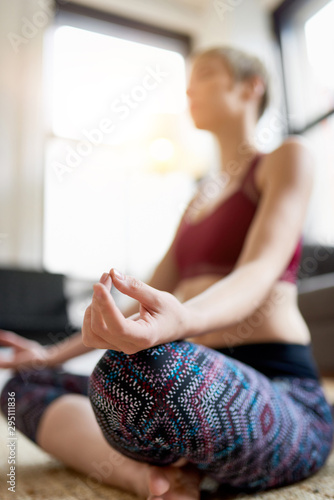 Trendy woman doing yoga as part of her mindfulness morning routine photo