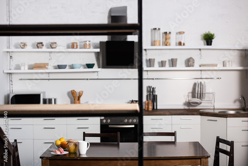selective focus of tasty dessert near bowl with fruits and cup of tea