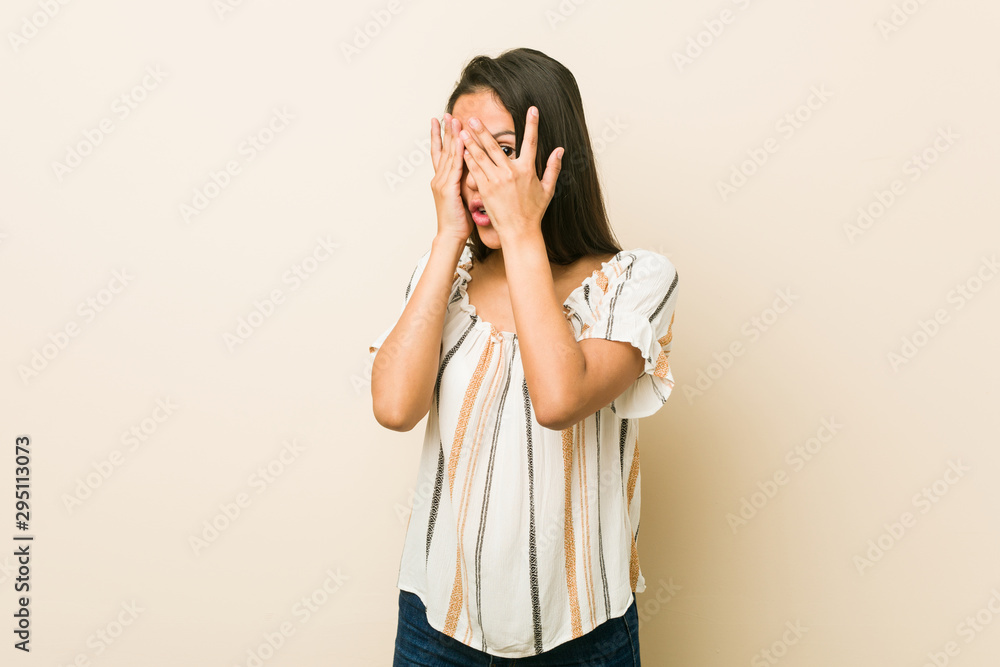 Young hispanic woman blink through fingers frightened and nervous. Young hispanic woman blink through fingers frightened and nervous.