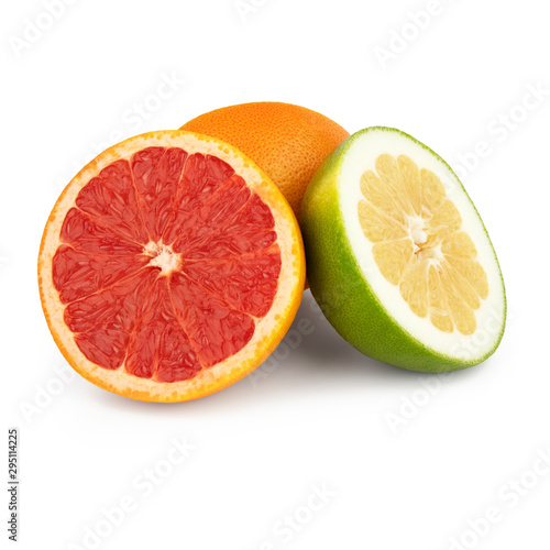 A group of green and orange grapefruit   pomelo is cut into pieces with juicy yellow and red pulp Isolated on a white background. Side view.