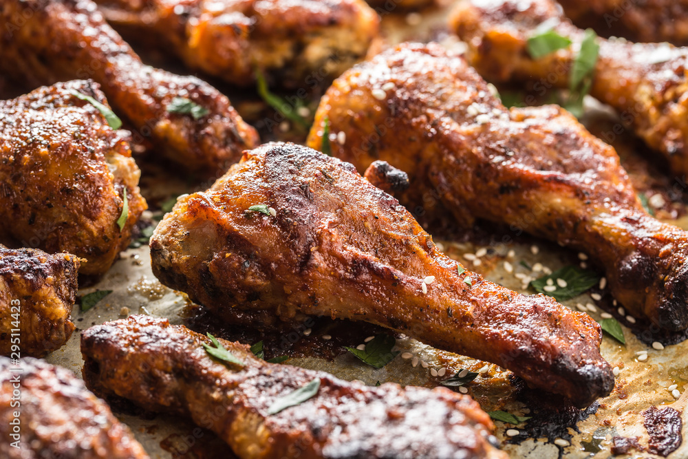 Roasted chicken legs barbecue on baked paper - Close-up Roasted chicken legs barbecue on baked paper - Close-up